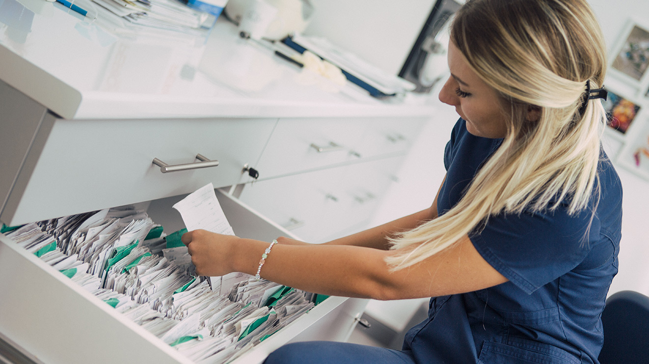 Woman sorting through patient files